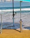 Beachmaster holding umbrellas