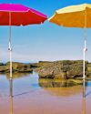 Beachmaster holding umbrellas